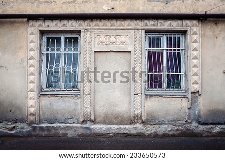 Aged weathered street wall with some windows
