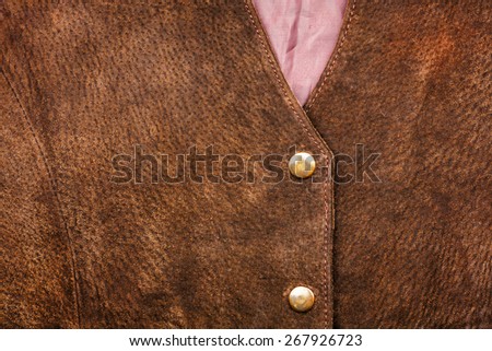 Fragment of brown suede vest