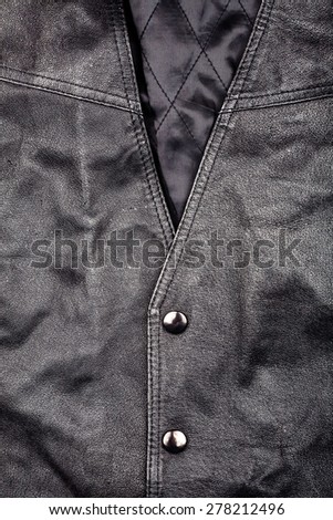 Fragment of black leather vest