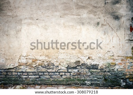 Old weathered wall of bricks and a ground