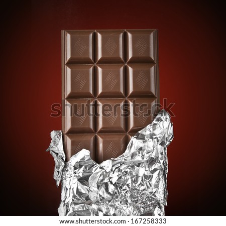 chocolate bar with open cover on dark background