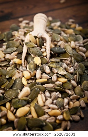 mixed seeds over wooden background