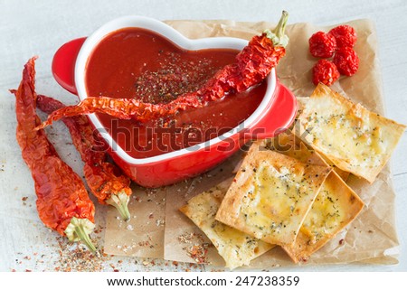 Spicy tomato soup with red pepper and cheese crisps