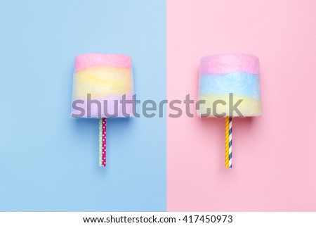 Top view of the Multicolored cotton candy. Minimal style. Pink and blue background