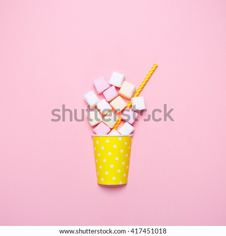 Top view of the pastel marshmallows on a pink background. Minimal style.