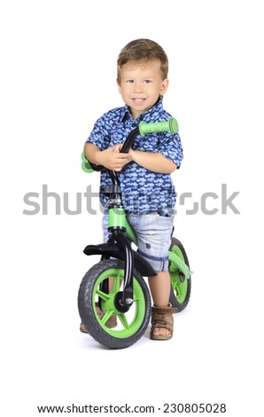 Baby boy on bike isolated on white background