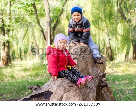 Happy brother and sister having fun in autumn park.Happy lifestyle kids