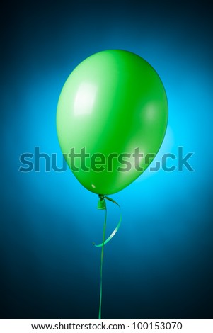 festive green balloon on blue