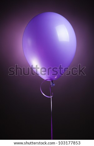 festive purple balloon on violet background