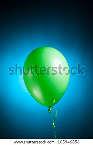 festive green balloon on blue