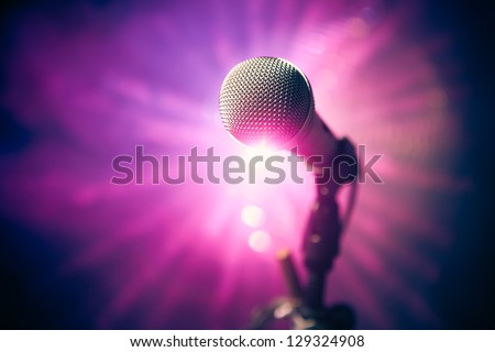 microphone on stage against purple rays