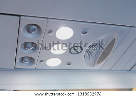 overhead light and air conditioner in airplane cabin