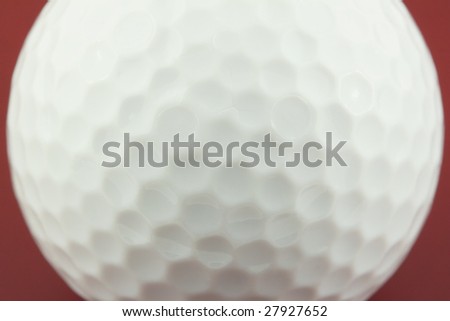 golf ball closeup on red surface