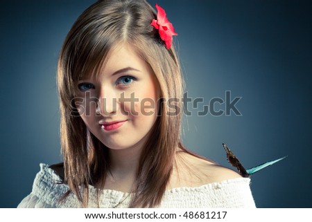 beautiful girl and butterfly on her shoulder