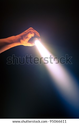 hand holding glowing pocket torch light