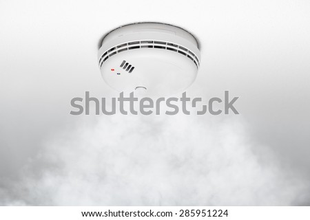 smoke detector of fire alarm in action, white background
