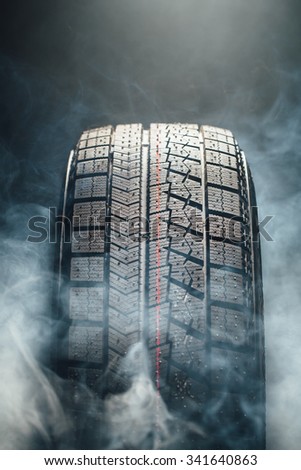 winter tire in smoke, closeup view