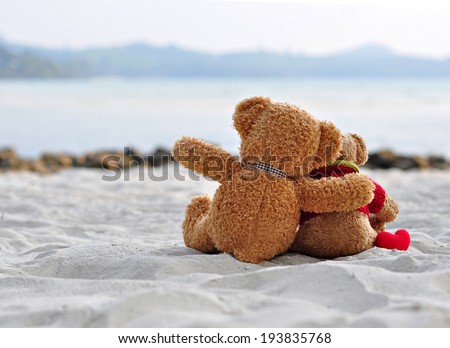 Teddy bears sitting on the beautiful beach with love. Concept about love and relationship