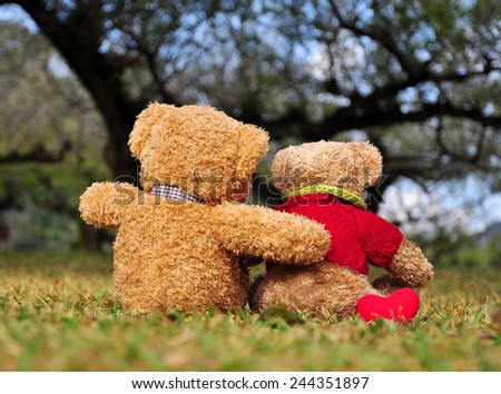 Two teddy bears sitting in the garden with love. Concept about love and relationship
