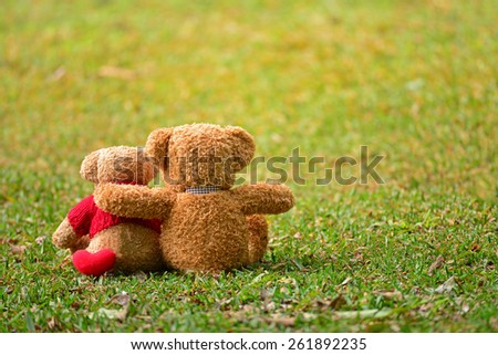Two teddy bears sitting in the garden with love. Concept about love and relationship