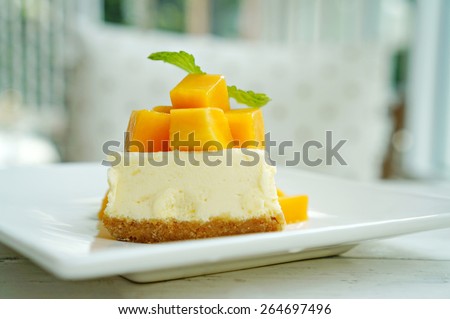 Mango cheesecake on white plate