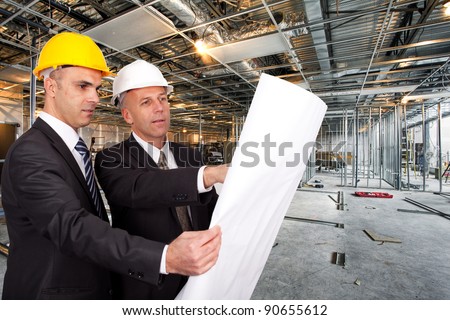 Engineers looking at a plan on a construction site