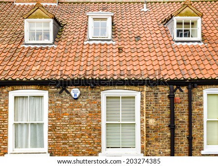 YORK, NORTH YORKSHIRE, UNITED KINGDOM: JULY 5TH. A house front, roof tiles and dormer windows inset into the roof. York, North Yorkshire, United Kingdom. July 5th 2014.