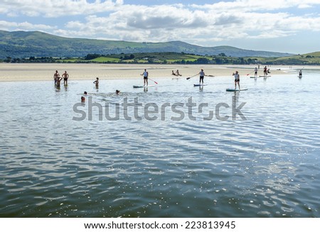 PORTMEIRION, NORTH WALES - SEPTEMBER 7TH: People paddle boarding on the River Dwyryd, on 7TH September 2014 in Portmeirion, North Wales, UK.