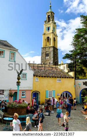 PORTMEIRION, NORTH WALES - SEPTEMBER 7TH: \'The Campanile\' bell tower rises above Portmeirion town square as various unidentified tourists come and go. 7TH September 2014, Portmeirion, North Wales, UK