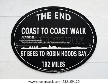 ROBIN HOOD\'S BAY, ENGLAND - SEPTEMBER 2014: A plaque marks the East Coast end, at Robin Hood\'s Bay, of the Coast To Coast Walk. 16TH September 2014, at the Bay Hotel, Robin Hood\'s Bay, England.