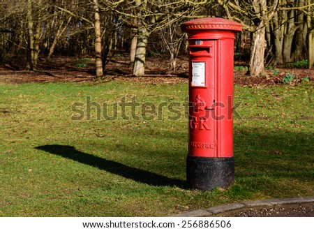 NEWSTEAD ABBEY, NOTTINGHAMSHIRE, ENGLAND - MARCH 1: A red, British Royal Mail post box in the grounds of Newstead Abbey, Nottinghamshire, England. On 1st March 2015.