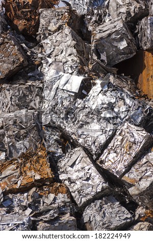 Recycled Scrap Metal Cubes - Cubes of crushed metal loosely stacked in a large pile.