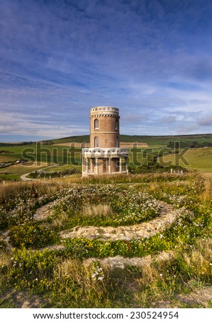 Cliff-top folly on the Dorset coast, England. The tower was dismantled and moved thirty feet away from the cliff to avoid being lost over the edge.
