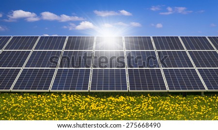 Sun glares on pristine photovoltaic panels under blue skies