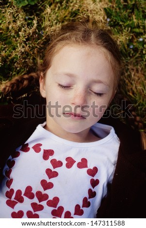 Young girl laying down outside