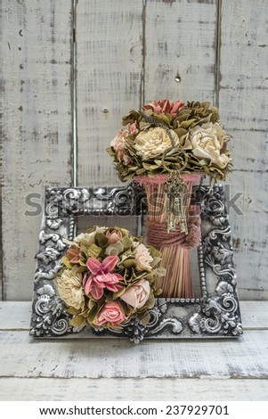 rustic decor setup with bouquets and keys in a vintage picture frame
