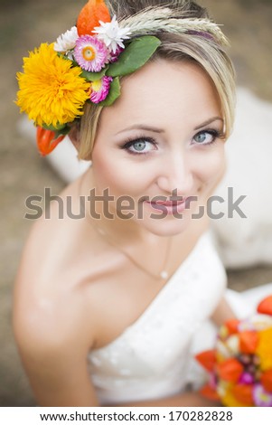 Beautiful bride holding flower bouquet and smiling