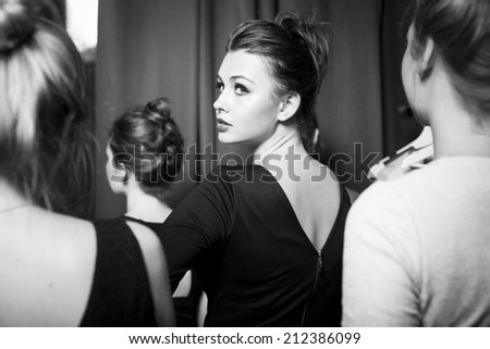 Plus size fashion models prepared for runway by stylish designer. Black and white photography