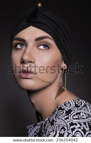 Close up portrait of a Young beautiful man in turban and with chains on his face