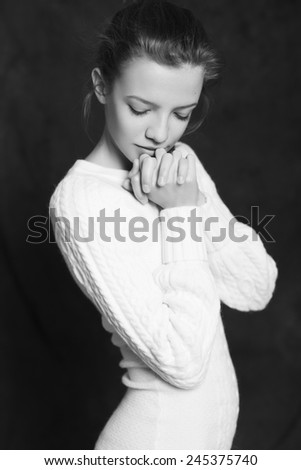 Beautiful woman in white sweater on black background. Black and White. Monochrome portrait. Dramatic. Sensual