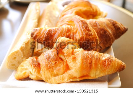 close-up of french breakfast with croissants and french toast in white plate
