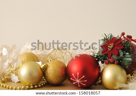 red and golden christmas baubles with white garland in white background
