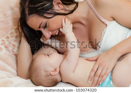 Mother and  her sweet  baby in the room at home. Happy family.