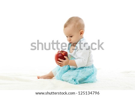 Sweet small baby with a fresh red apple on a white background Sweet small baby with a fresh red apple on a white background