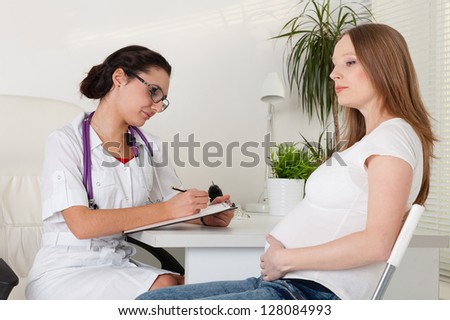 Pregnant woman visiting  doctor in clinic.