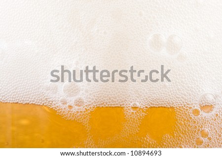 Background from fresh foamy beer with bubbles. Close-up.