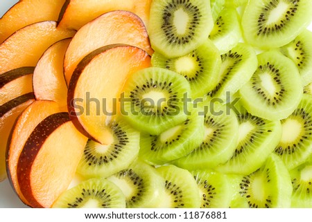 Background from sliced kiwi and plums.