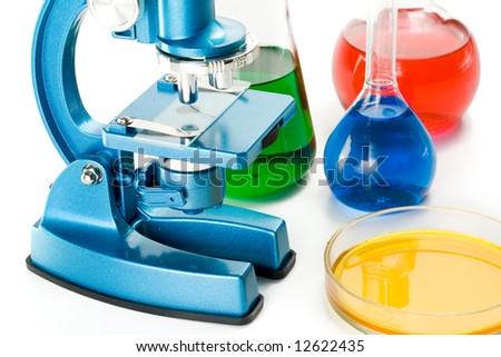 Various colorful flasks and blue microscope over white background
