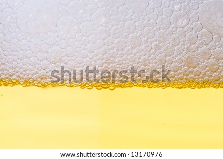 Background from fresh foamy beer with bubbles. Close-up.