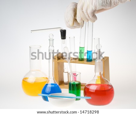 Various colorful glass laboratory ware on a white background